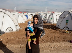 Refugee-mother-with-baby-in-tent-camp-ivor-prickett-visum-768x564-1